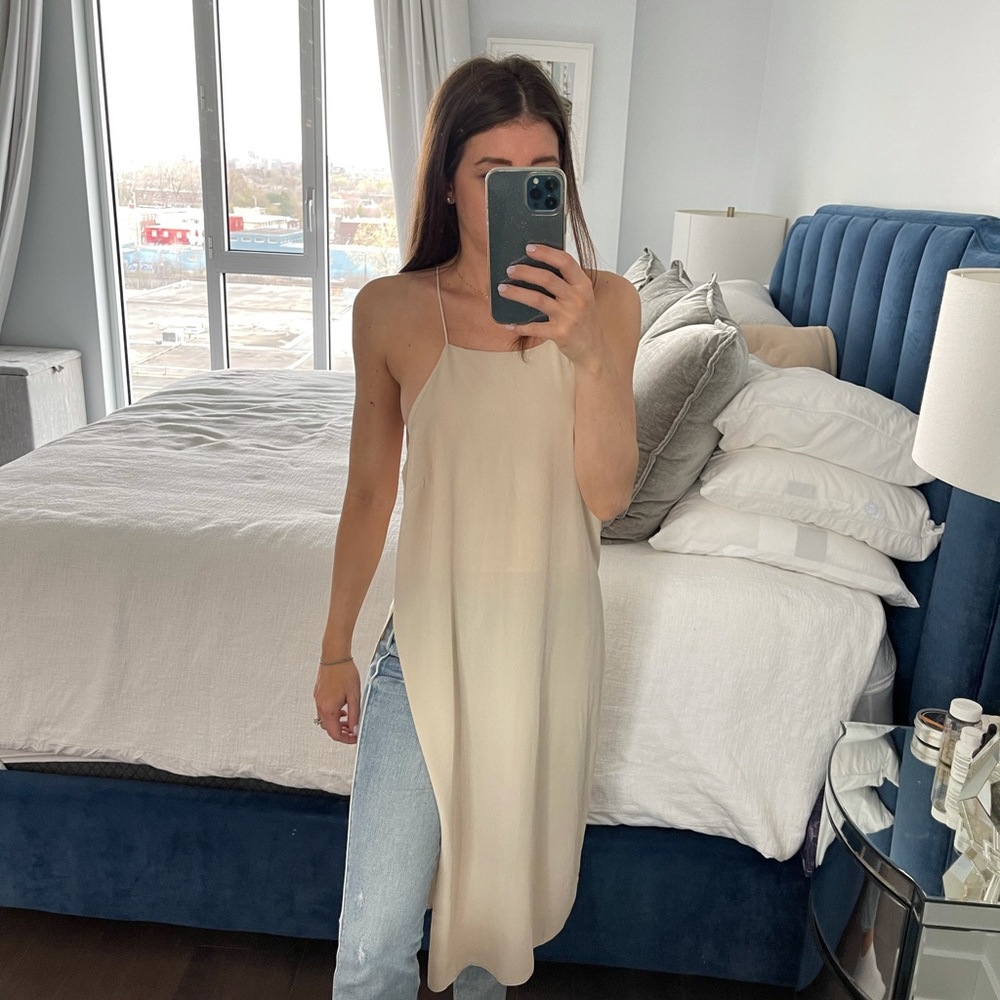 Beige long tank with slit.